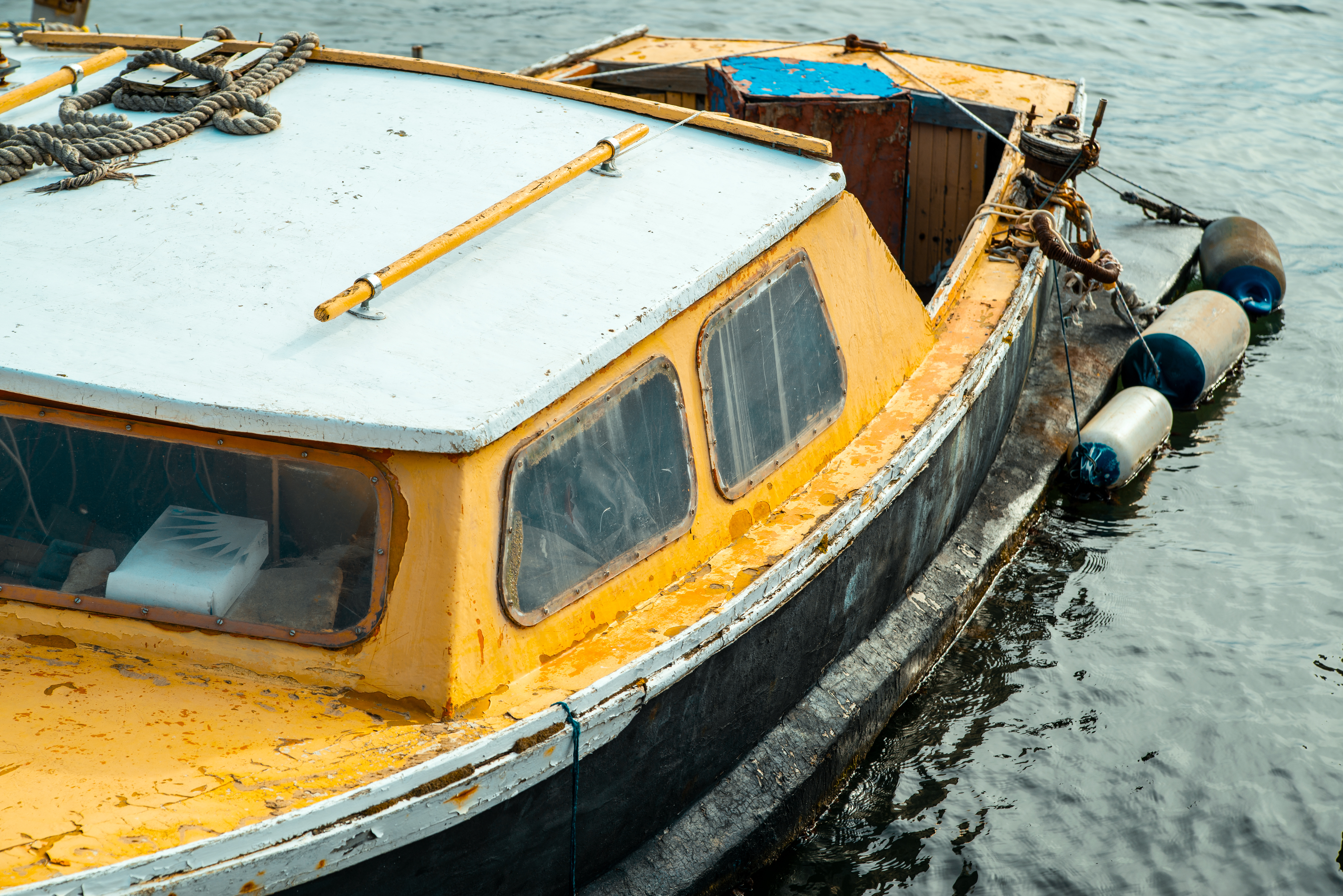 A yellow boat floating in water.